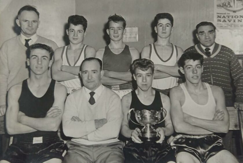 Jimmy shown front holding a cup after the Midlands boxing championships on the road to the British finals.