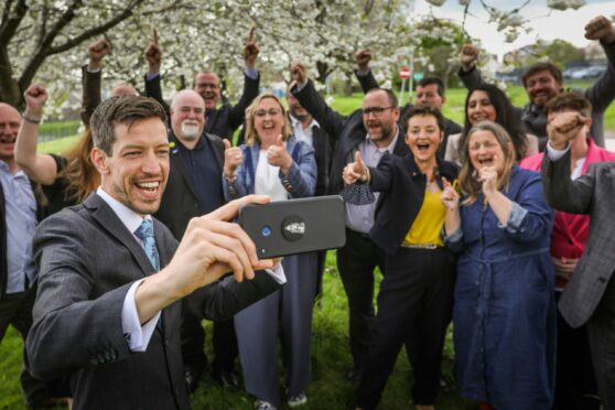 John Alexander takes a selfie with the SNP group as they celebrate a majority win.