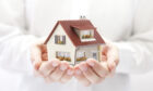 Figurative image of hands holding a house - Is your inheritance protected