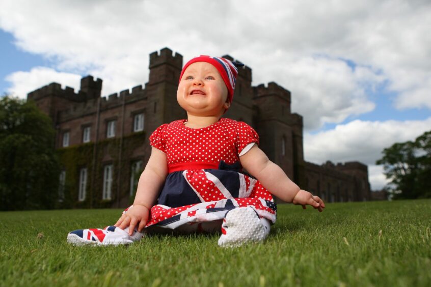 Diamond Jubilee celebrations at Scone Palace, Perth. 8 month old, Scarlett Glen (from Liff, Dundee) in a Union flag outfit enjoying the day.