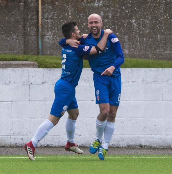 Ross Campbell celebrates a goal with Terry Masson in 2019.