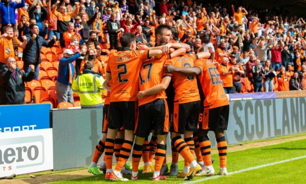 United celebrate in front of a packed stand at Tannadice