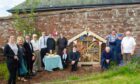 Webster's pupils and staff with Kirrie Connections visitors at the bug hotel opening