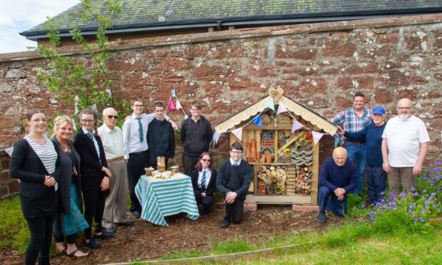 Webster's pupils and staff with Kirrie Connections visitors at the bug hotel opening
