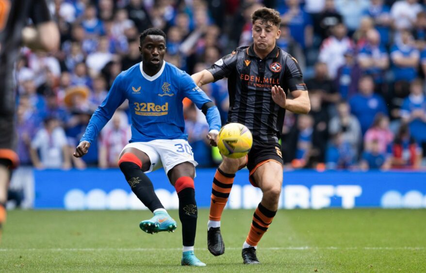 Rangers' Fashion Sakala is challenged by Lewis Neilson during Dundee United's May clash with Rangers at Ibrox