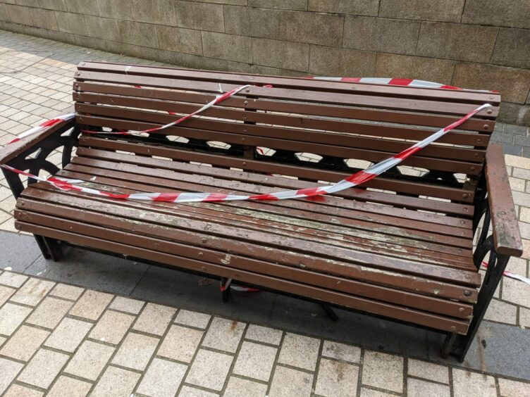 The benches on Dundee's Albert Square have been taped off