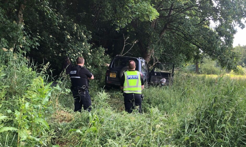 Police at the stolen car abandoned in Finlathen Park.