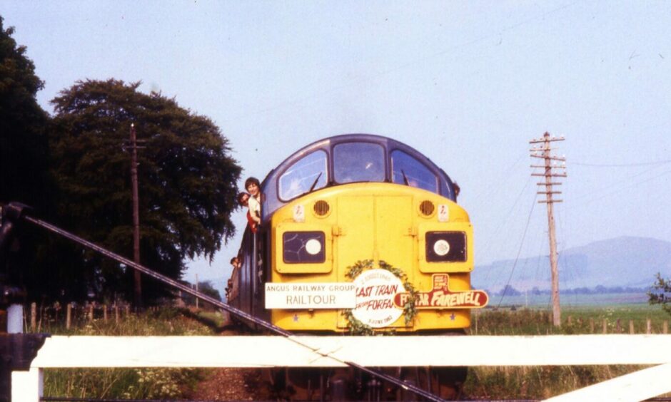 The special train pulls up at the Ardler level crossing near Camno.