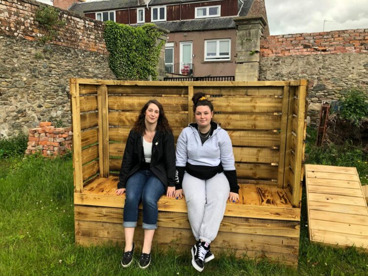 Sam Stewart and Bethany Hart on one of the benches, which is yet to be decorated.