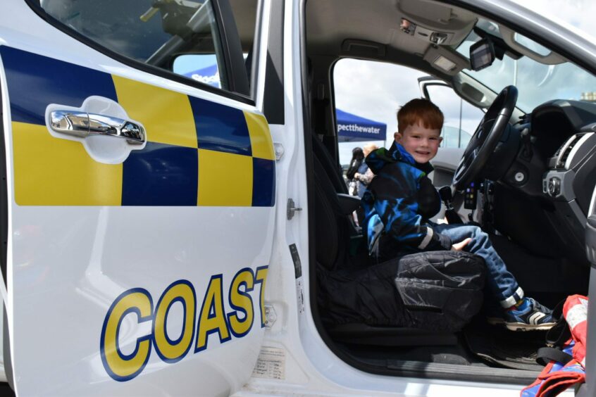 Finton Thomson, 6, taking a seat at the wheel of a coastguard van at the Broughty Ferry RNLI open day.
