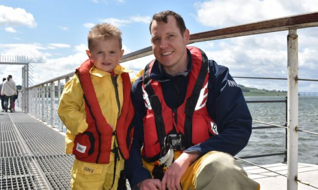 Nathan McIntosh, 4, from Arbroath with volunteer crew member Scott Kidd at the Broughty Ferry RNLI open day.