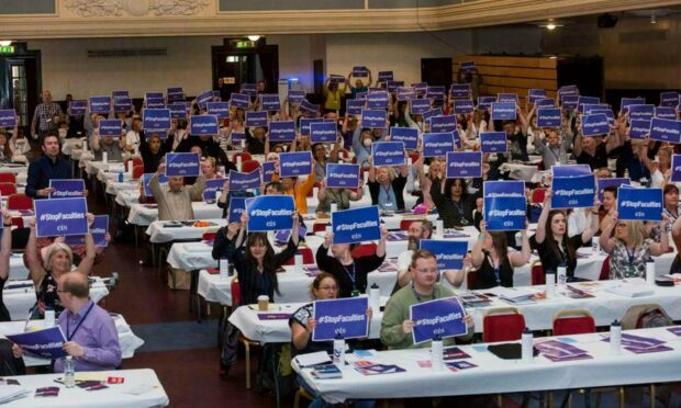 EIS members at hold up 'stop faculties' banners at union AGM ahead of Dundee teachers strike.