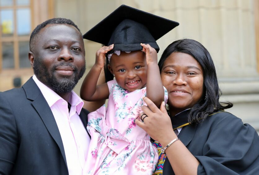 Esther Amo- Mensah graduated today in social work, with daughter Eva, 2, and husband Elvis,