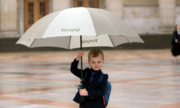 Max May, 5, from Broughty Ferry attending his sister's graduation in the rain in Dundee on Thursday.