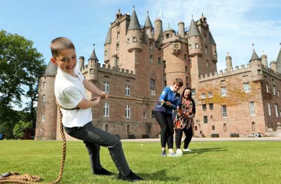 Nine-year-old Marshall Cochrane gets in some tug-o-war training with his mum, Lorna and Fiona Walsh of Redcastle Gin ahead of Sunday's Strathmore Games at Glamis Castle. Pic: Gareth Jennings/DCT Media.