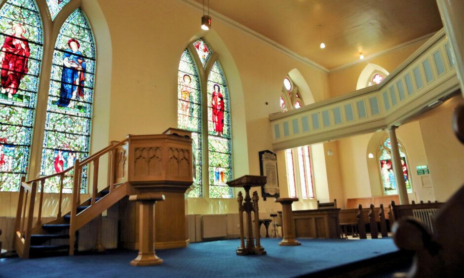 St Rules Church features large stained glass windows and wooden interiors.