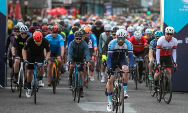 Picture shows hundreds of cyclists going over the start line in 2022's Etape Caledonia.