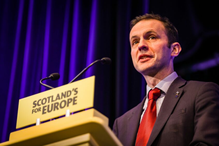 photo shows Stephen Gethins at a lectern with the words 'Scotland's for Europe' written on it.