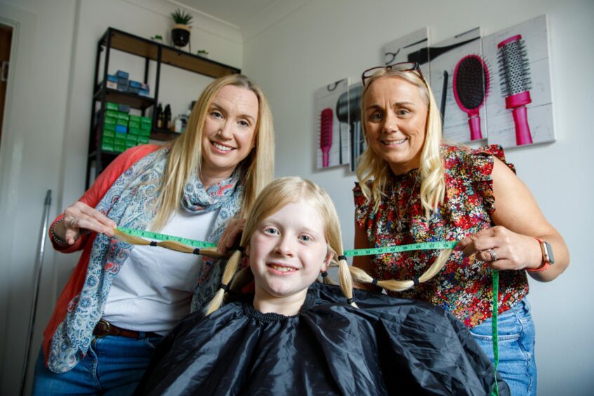 Logan with Mum Marie Reid (left) and hairdresser Michelle Crawford from Fusion Hair by Michelle in Dunfermline