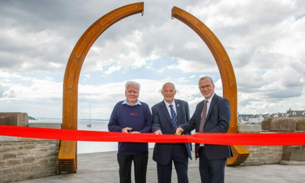 Mark Flynn convener of Dundee City Council's city development committee, Robin Smith MBE former crew member of the lifeboat Mona and RNLI Broughty Ferry President David Martin in front of the new statue.