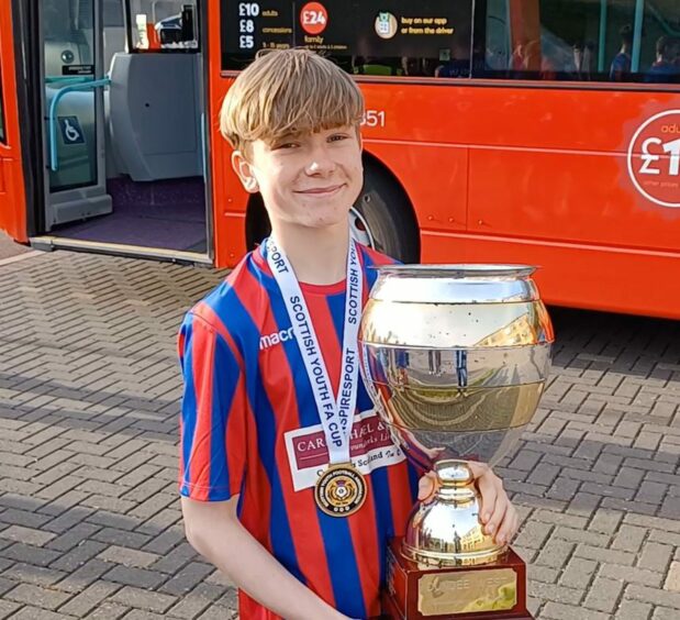 Keiran Luke with the Dundee West Anniversary Tophy.