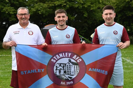 Scotland and Chelsea star Billy Gilmour took in a charity football match in Stanley, Perthshire. Gilmour is pictured with Stanley Amateurs' Kenny Alexander (left) and Alfie Alexander. Credit: Stuart Cowper.