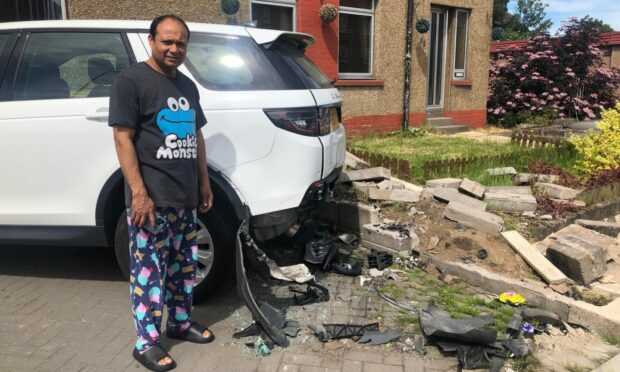 Sanat Ghatak with his damaged car at his home in Douglas.