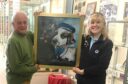 Dr Andrew Orr of Montrose Heritage Trust presents the Bamse painting to Sian Brewis of Montrose Air Station Heritage Centre. Supplied by MAHSC.