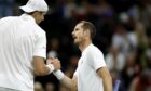 Andy Murray (right) shakes hands with John Isner after defeat in the second round match.