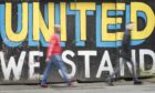 A general view of people walking past graffiti in Leeds.