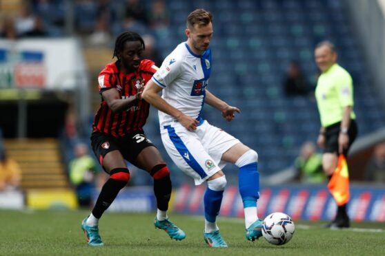 Blackburn Rovers' Ryan Hedges (right) takes on Bournemouth.