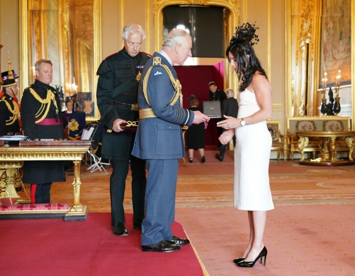 Eve Muirhead is made an OBE by the Prince of Wales at Windsor Castle.