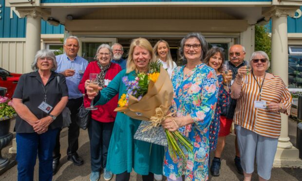 Staff at The Scottish Antique and Arts Centre celebrate 25 years in business as chief executive Tracy Welsh receives flowers from owner Elaine Templeman.
