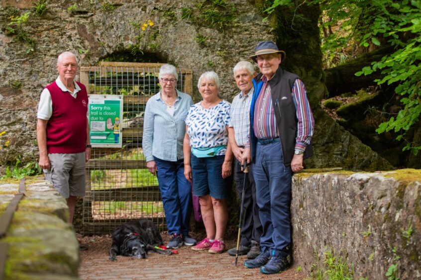 David MacDougall, Isobel Price, Sheila MacDougall, Bill Bray and Ian Nimmo with Millie the dog in front of the blocked Hermitage path
