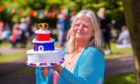 Sadie Harris, from Cupar, with her Platinum Jubilee cake and cake cover. Picture Steve MacDougall/DCT Media.