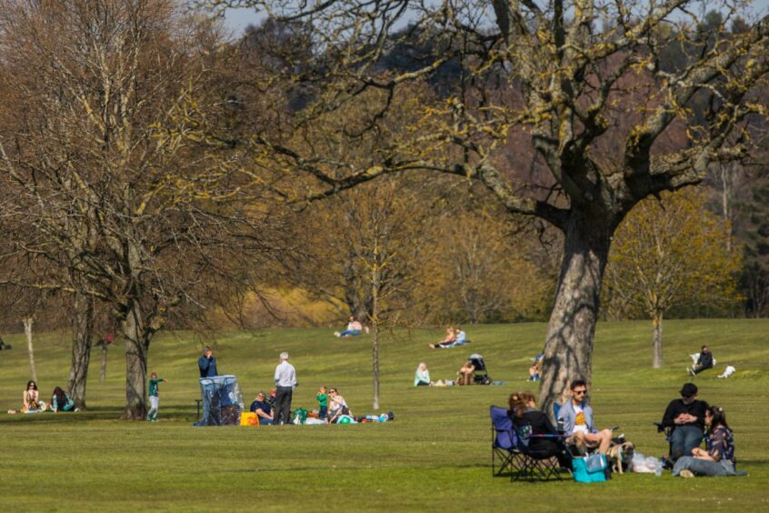 People enjoying a sunny day on the north inch, Perth