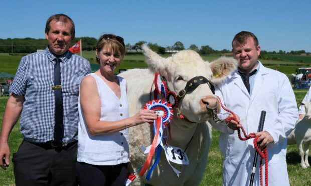 REWARDING: Show chairman Russell Wood and his wife Jackie preent the champion of champions award to Jamie Rettie who brought out the winner for Brailes Livestock.