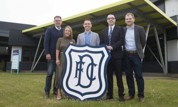 Dundee FC community chief Greg Fenton (second right) has outlined plans for those struggling with the cost of living crisis to use Dens Park. Image: David Young