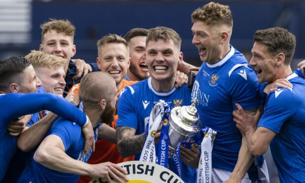 Craig Bryson (right) watches Jason Kerr lift the Scottish Cup.