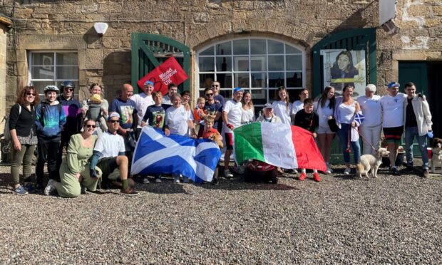 Cura family and friends with cyclists outside Pete's Gallery before Cupar departure