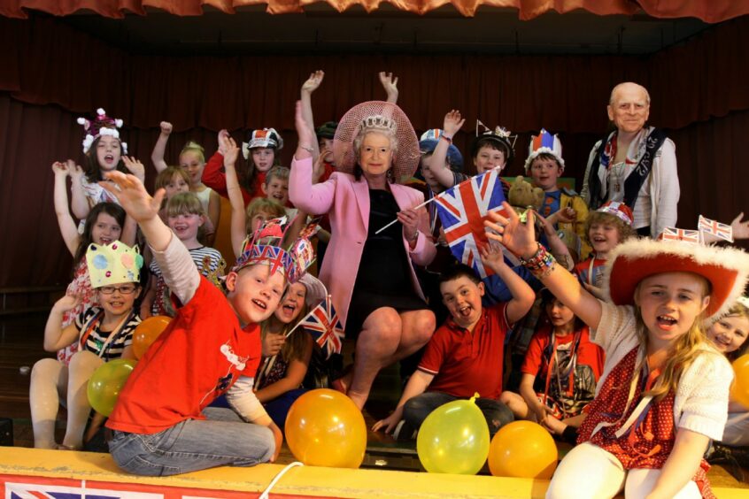 Diamond Jubilee celebrations - Mrs Cox, head teacher of St Vincent's Primary School, Dundee is dressed as the Queen and is pictured with the Jubilee Entertainers who are a mix of kids from all the primary classes at the school.