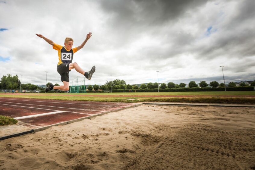 Alfie Field, 11, from Dunning PS takes on the long jump.