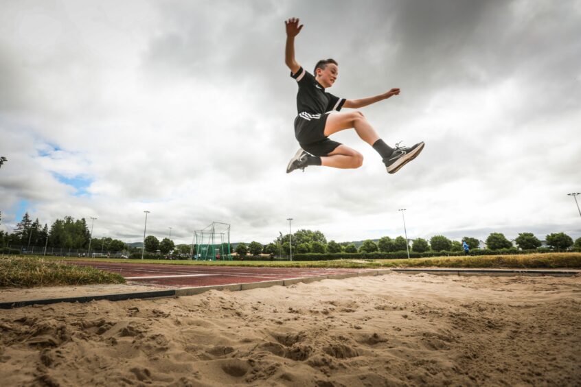 Charlie Duncan, 11, from Crieff PS takes on the long jump