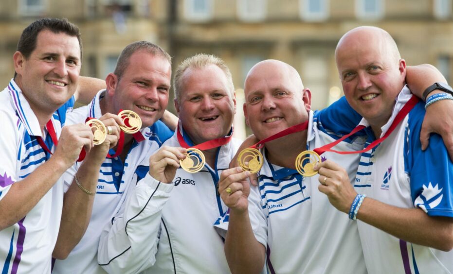 Darren, centre, with his Commonwealth Games gold medal.