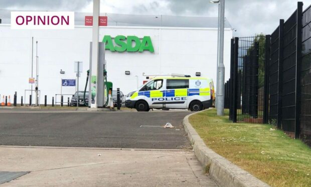 A police van parked outside Asda in Kirkton at lunchtime on Tuesday.