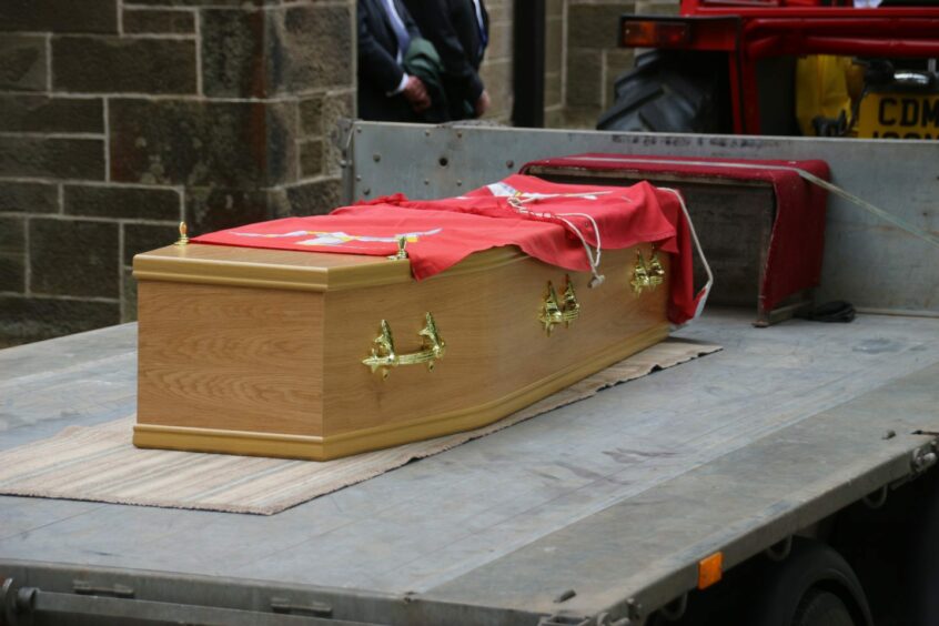 John's casket covered with the Manx flag.