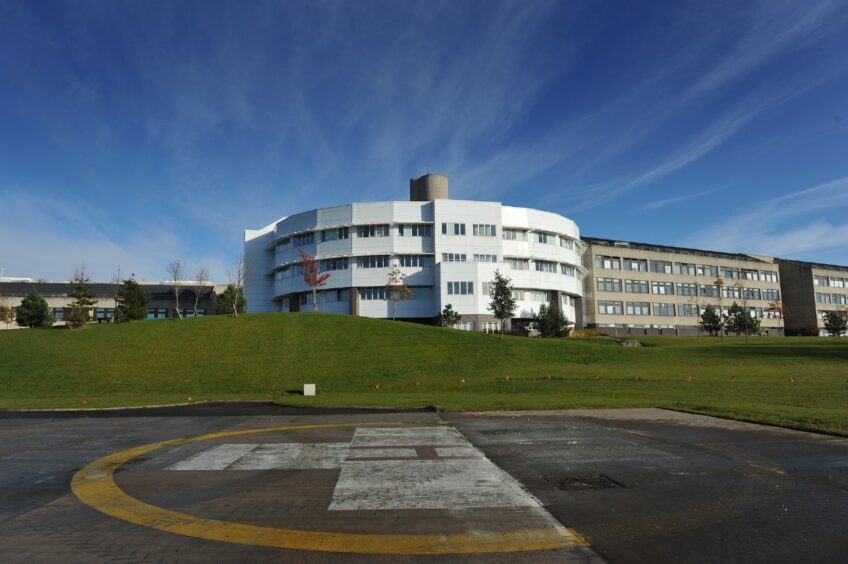 The Ninewells Hospital building in Dundee with the helipad in the foreground. 