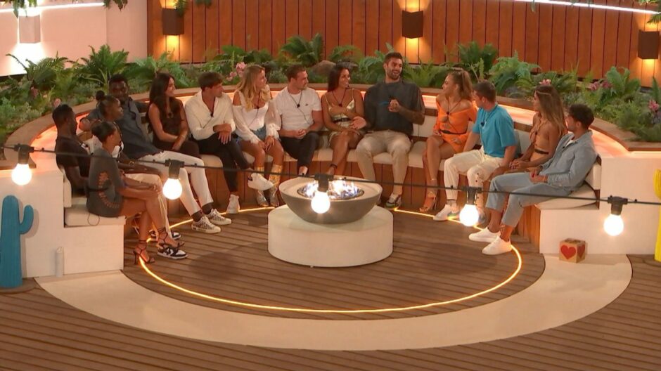 Islanders at seating area in a scene from most recent series of Love Island.