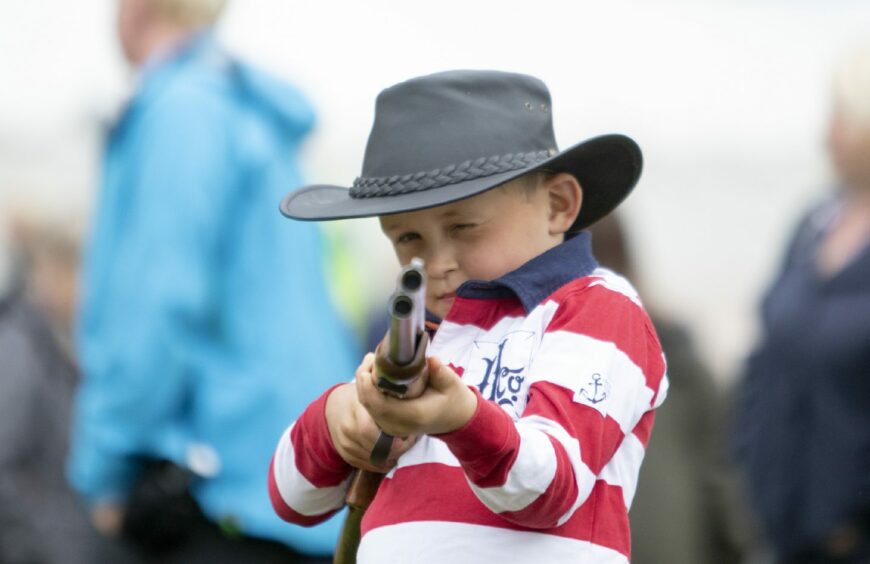 A young visitor tries laser clay pigeon shooting at the 2019 games