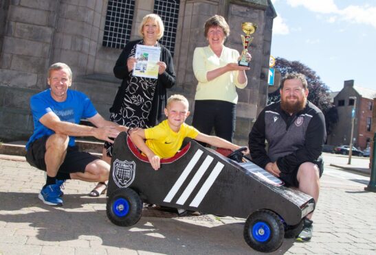 Jed Cargill, 7, trying out Arbroath FC Community Trust's cartie with (from left) David Durno, Brenda Durno, Maureen Beedie and Ryan Beattie. Pic: Paul Reid.